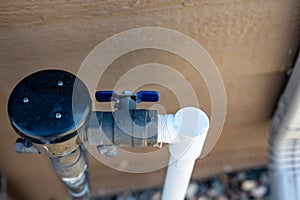 Test cocks, shut off valves, and vacuum breaker to a lawn sprinkler irrigation system on the outside of a residential house