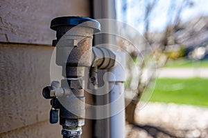 Test cocks, shut off valves, and vacuum breaker to a lawn sprinkler irrigation system on the outside of a residential house