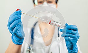 Test for coronavirus Covid-19. Female doctor or nurse doing lab analysis of a nasal swab in a hospital laboratory. photo