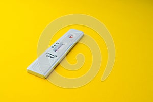 test for coronavirus lies on a yellow background. a drop of blood on a test strip. rapid diagnosis of coronavirus  laboratory test