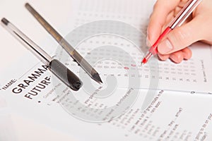 Test of English multiple choice on table.Woman takes an entrance exam