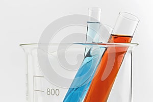 Test tube with red liquid (fluid, water) in the beaker