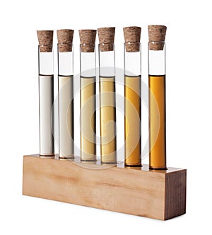 Test tubes with brown liquid in stand on white background