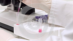 Test tubes closeup. Medical equipment. Close-up footage of a scientist using a micro pipette in a laboratory. injecting