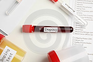 Test tubes and jars with samples on white table, above view. Doping control