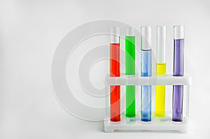 Test tubes with multi-colored reagents on a white background. chemistry