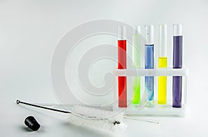 Test tubes with multi-colored reagents on a white background. chemistry