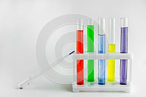 Test tubes with multi-colored reagents on a white background. chemistry