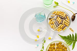 Test tubes with plants in a holder, vitamins on a light background, laboratory