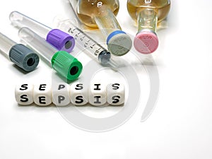 test tubes, syringe, hemoculture bottles, and silicone letters photo