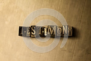 TESTIMONY - close-up of grungy vintage typeset word on metal backdrop