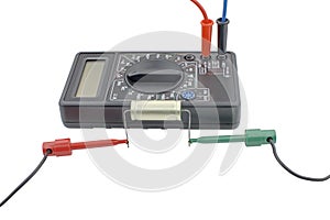 Testing capacitor with multimeter on white