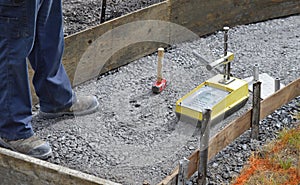 Testing the compaction of a newly compressed gravel sidewalk photo