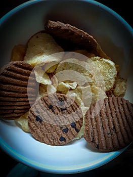 Testy chips and biscuits in bowl