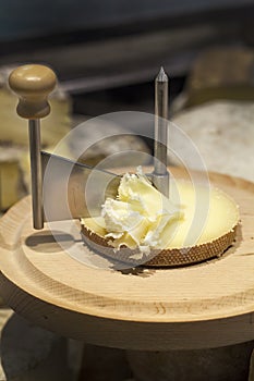 Tete de moine raw milk cheese with girolle on cutting board photo