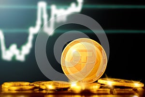 TETHER USDT cryptocurrency; TETHER golden coin on the background of the chart