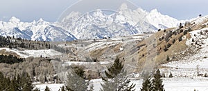 Teton mountain range behind forests, foothills, and fields