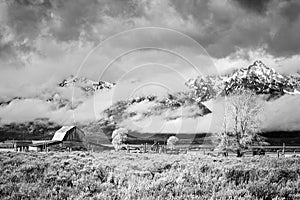 Teton Mountain Range with Moulton Barn in clouds.