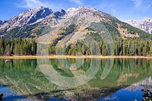 Tetons reflected in String Lake on a sunny autumn day