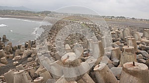Tetrapod breakwater at Glagah beach, Kulonprogo coastline photo