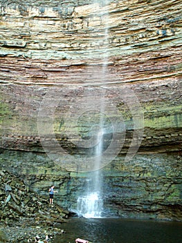 Young girl at base of Tews Falls, Spencer Gorge Conservations Area, Ontario, Canada