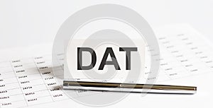 Tex DAT on stickers,pen on the background of documents. Financial bookkeeping, Accounting Concept. Top view