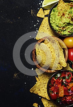 Tex-Mex Concept, Nachos, Guacamole, Salsa Sauce, Black Background, Top View photo