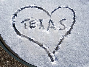 Texas and heart written on patio table snow