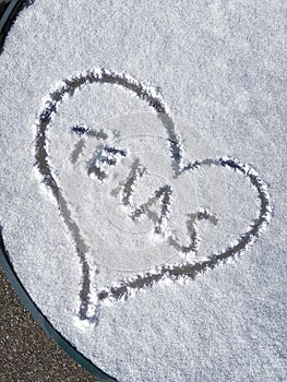 Texas and heart written on patio table snow