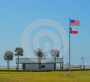 The Texas State Flag and American Flag on the Bolivar Peninsula on the Gulf of Mexico in Texas
