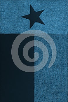 Texas state flag. Dark patriotic textured background. Blue tinted vertical backdrop. Symbol of one of the American states.