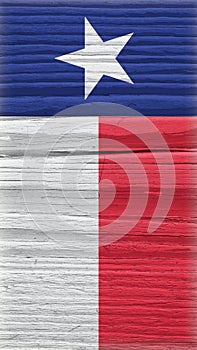 Texas state flag on dry wooden surface. Mobile phone wallpaper made of old wood. Lone Star State. Edge of the flag has faded like