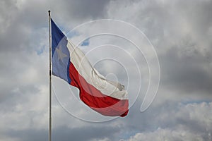 Texas State flag on the pole waving in the wing