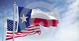 The Texas state flag waving along with the national flag of the United States of America
