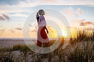 Texel lighthouse during sunset Netherlands Dutch Island Texel, girl visit the lighthouse , woman on vacation Texel