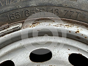 The text 165 65 showing width and aspect ratio of a tyre