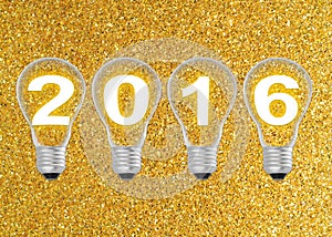 Text 2016 in lightbulb on gold glitter background