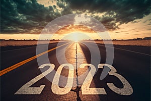 Text 2023 written on the road in the middle of asphalt at sunset. Concept of planning, goal, challenge, new year resolution