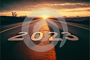 Text 2023 written on the road in the middle of asphalt at sunset. Concept of planning, goal, challenge, new year resolution