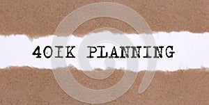 The text 401K Planning in appearing behind torn brown paper,busness