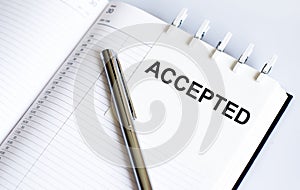 Text ACCEPTED on the short note texture background with pen