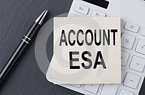 Text ACCOUNT ESA on sticker on the calculator, business concept