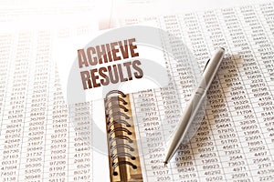 Text achieve results on paper card,pen, financial documentation on table - business, banking, finance and investment concept.