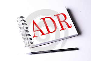 Text ADR on notebook on the white background