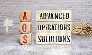 text Advanced Operations Solutions - AOS on wooden block photo