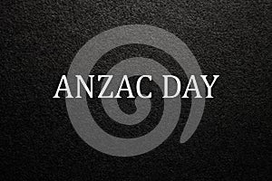 Text Anzac Day on black textured background. Anzac Day.