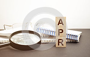 Text APR on a wooden cube blocks, business