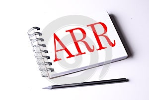 Text ARR on notebook on the white background photo