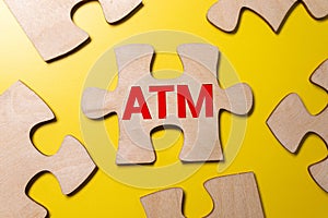 Text ATM on a yellow piece of paper for notes. Stationery Paper clips, crumpled paper. financial business concept