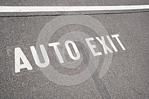 Text AUTO EXIT on road surface
